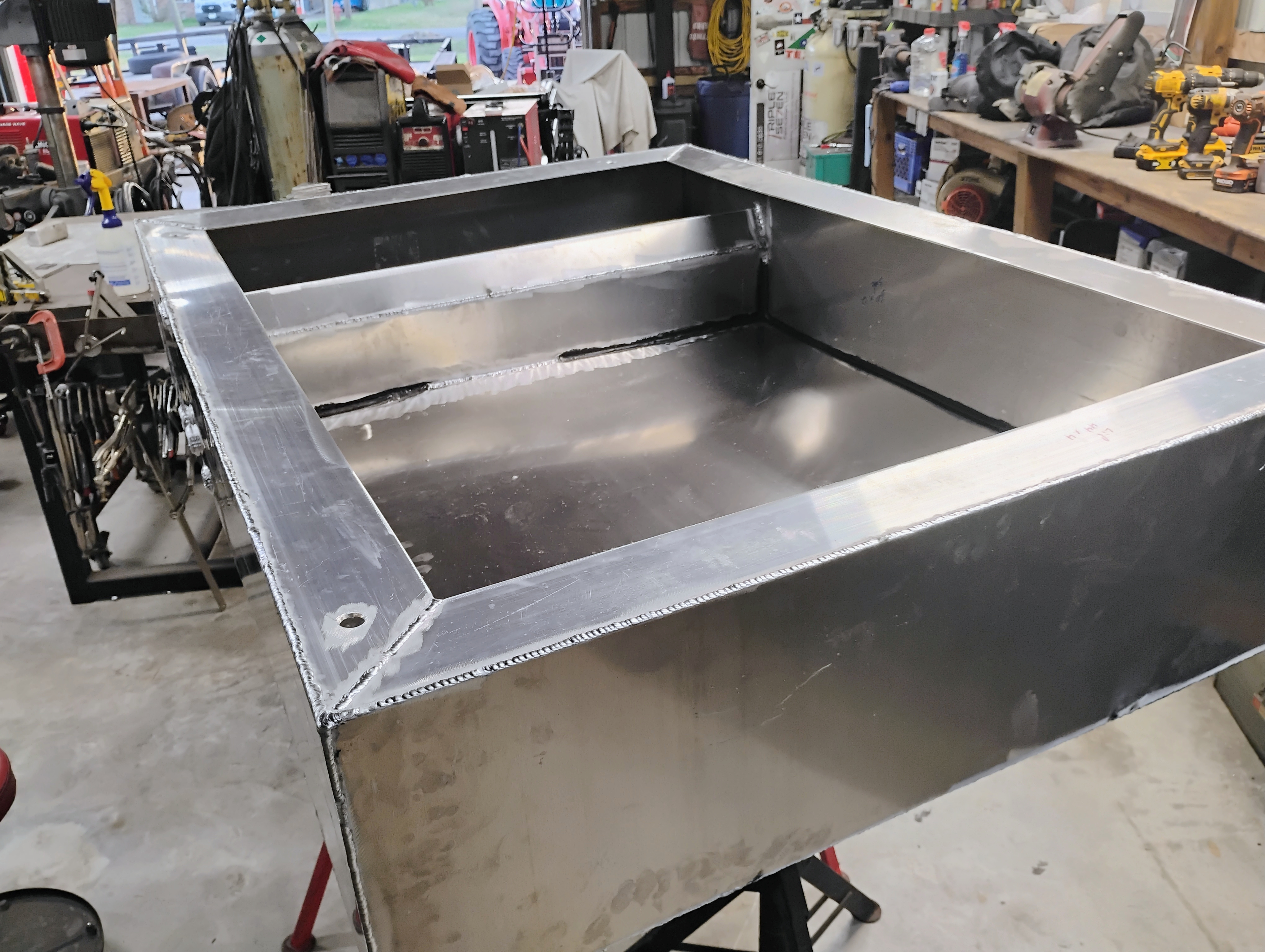 Interior view of custom stainless tank showing baffle and internal welding