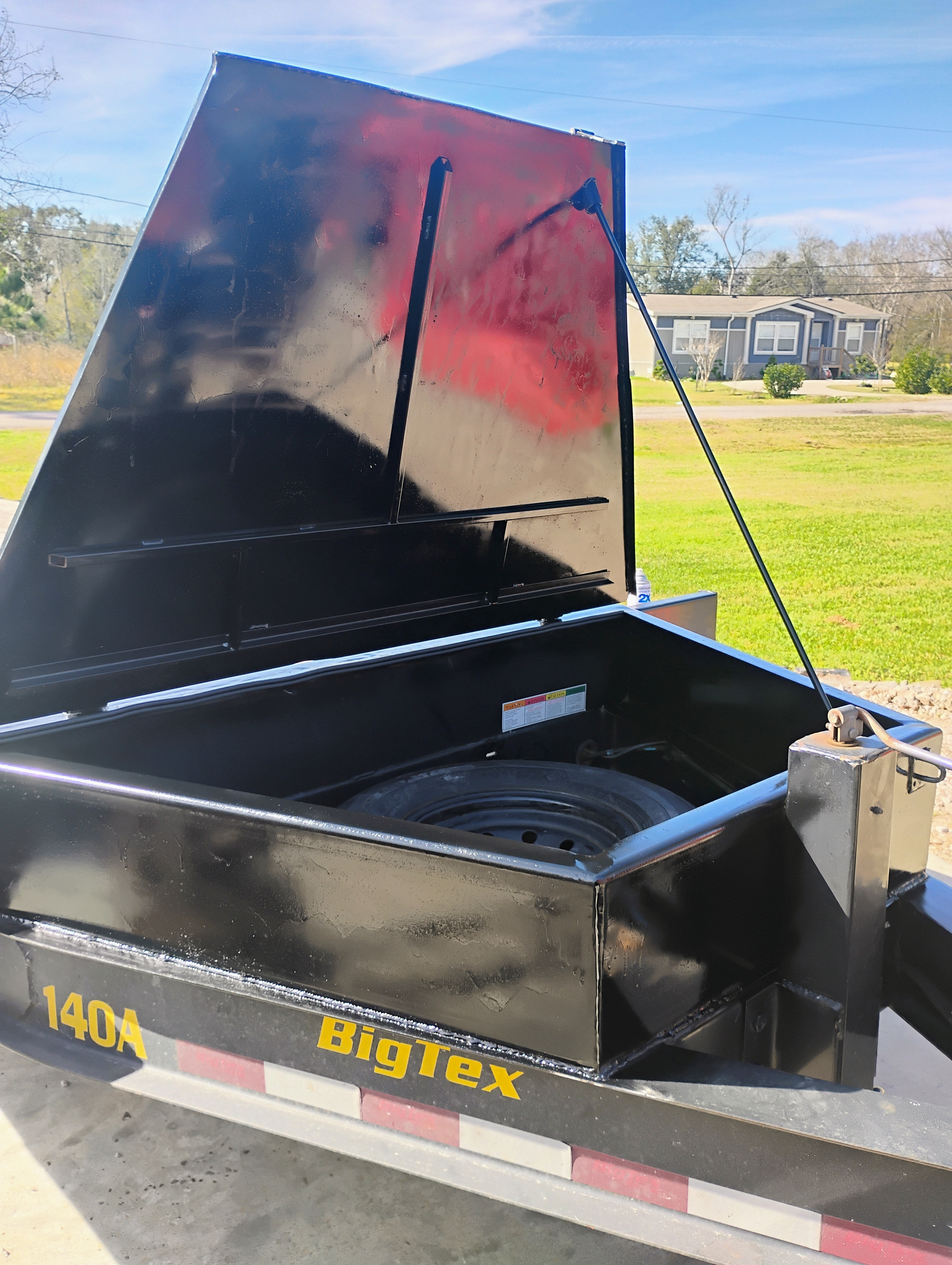 Trailer toolbox fabrication showing open storage bed