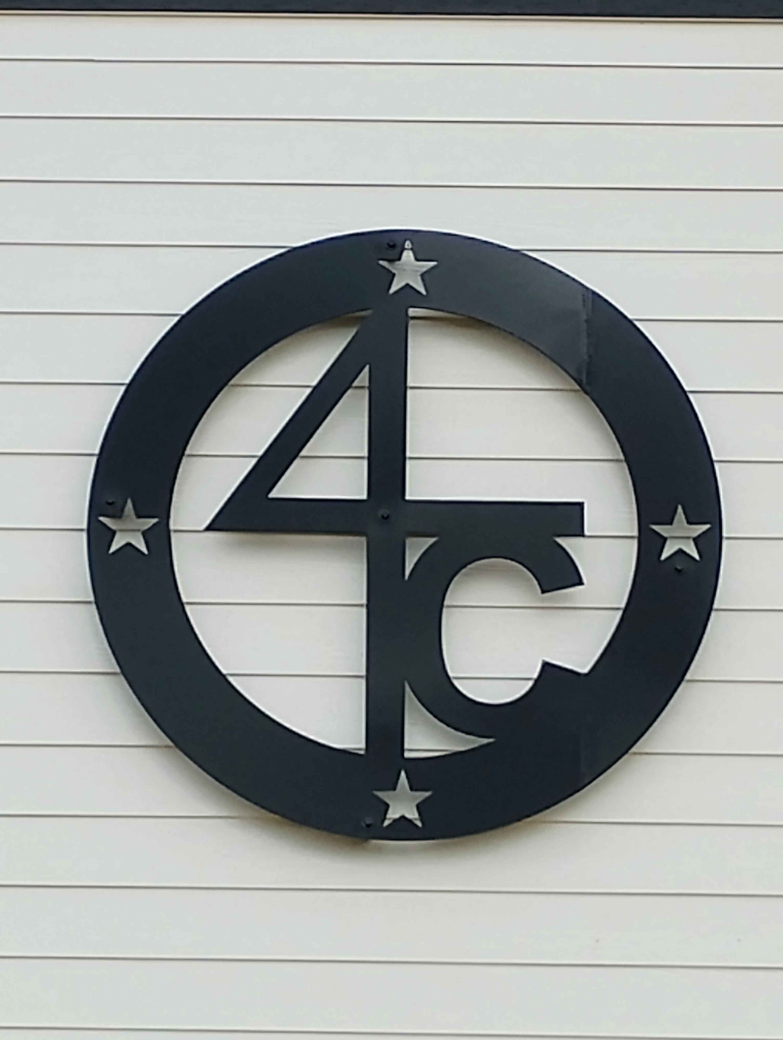 4C monogram sign installed on house front